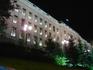 [iero] Le parlement, avec des lumières sur le toit, entre les arbres.